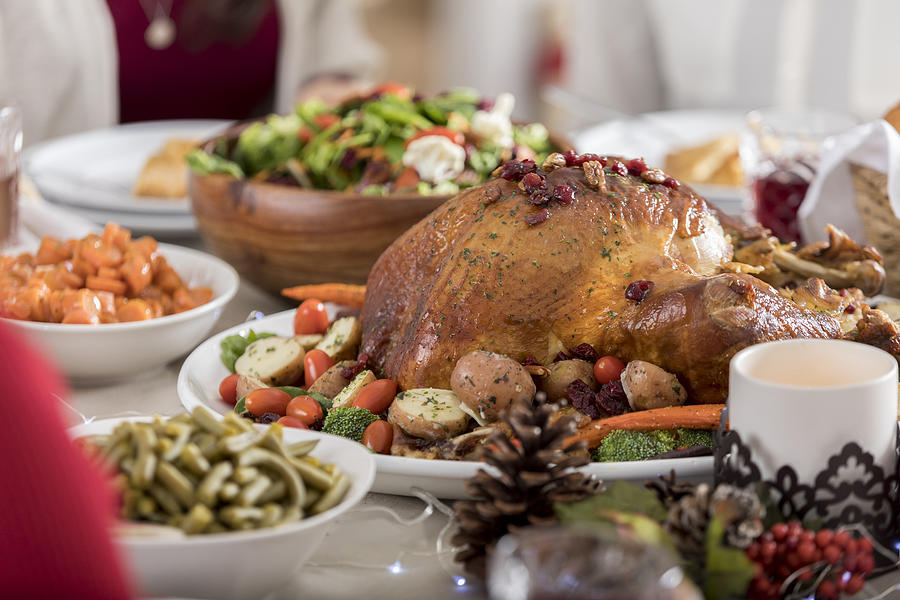 Christmas dinner turkey is centerpiece of full table Photograph by SDI Productions