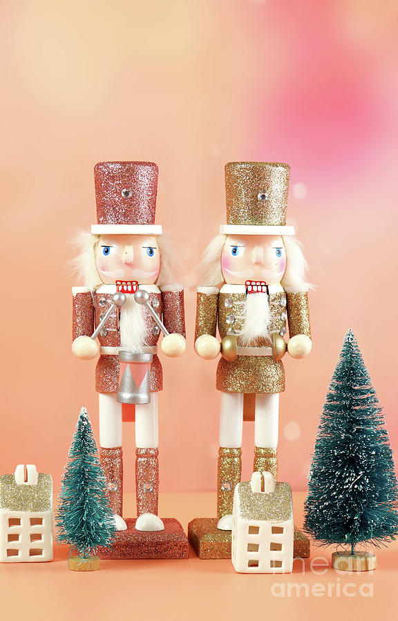 Christmas nutcracker ornaments and gifts against a modern coral background. Photograph by Milleflore Images