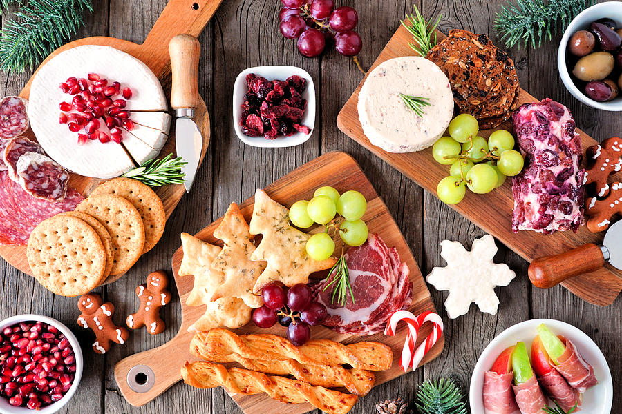 Christmas theme charcuterie top view table scene against dark wood Photograph by Jenifoto