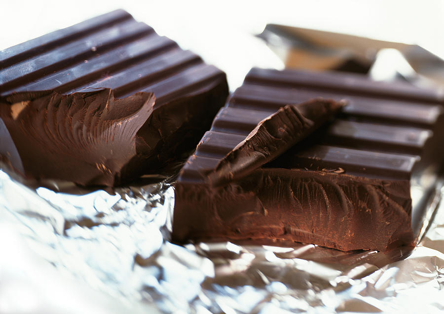 Chunks of dark chocolate on aluminum foil Photograph by Isabelle Rozenbaum