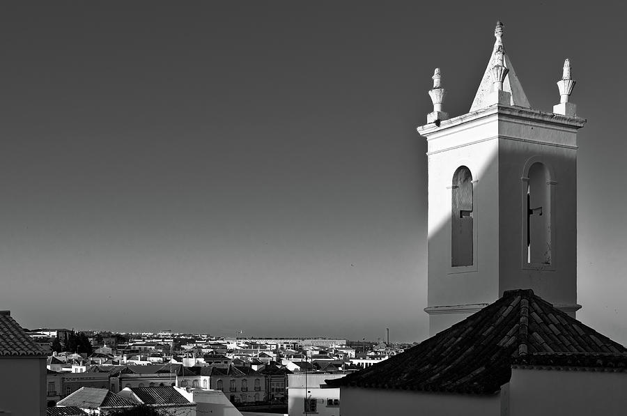 Church bell tower and city Photograph by Angelo DeVal