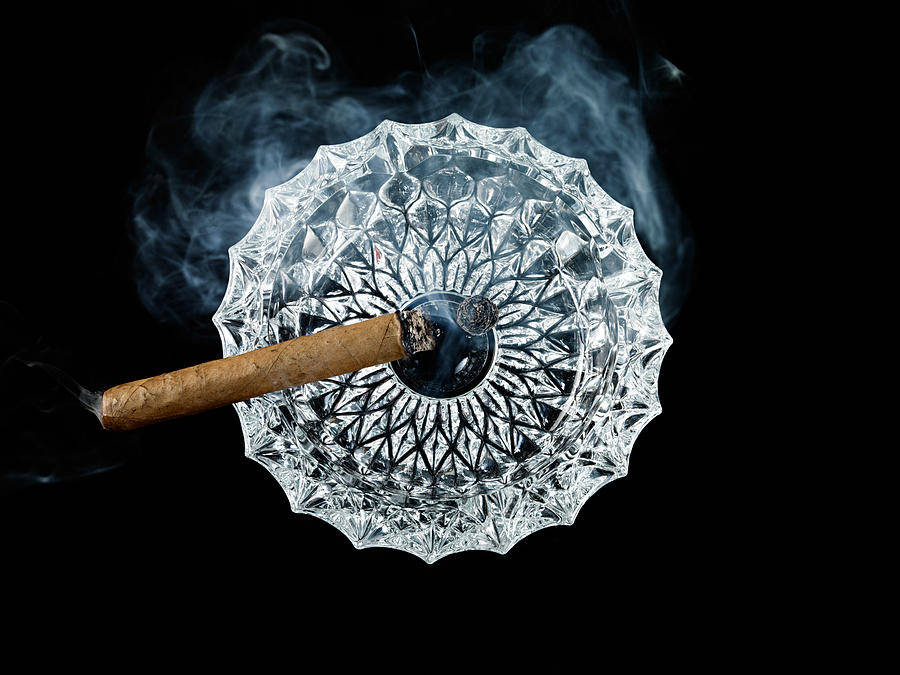 Cigar in ashtray Photograph by Image Source