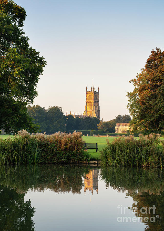 Cirencester Church at Sunrise Reflecting in the Abbey Lake Photograph by Tim Gainey