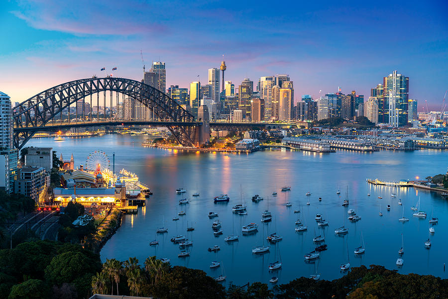 Cityscape image of Sydney, Australia with Harbor Bridge and Sydney skyline during sunset. Vacation and travel in Australia. Photograph by Prasit photo