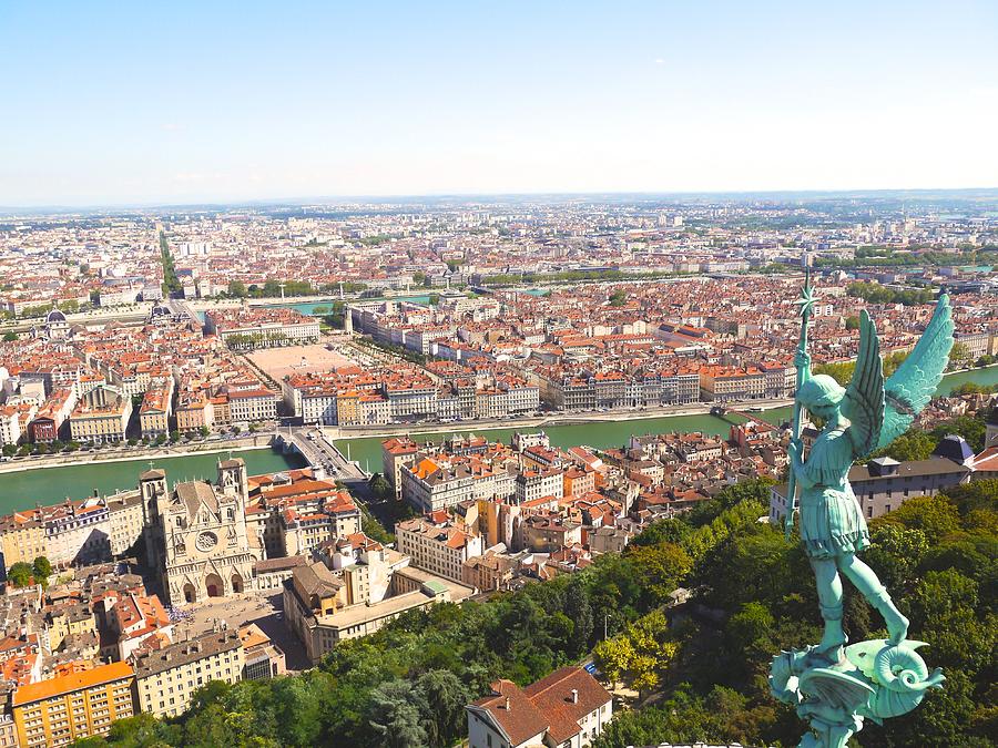 Cityscape with statue of angel, Lyon, France Photograph by Gabriel Zimmerli