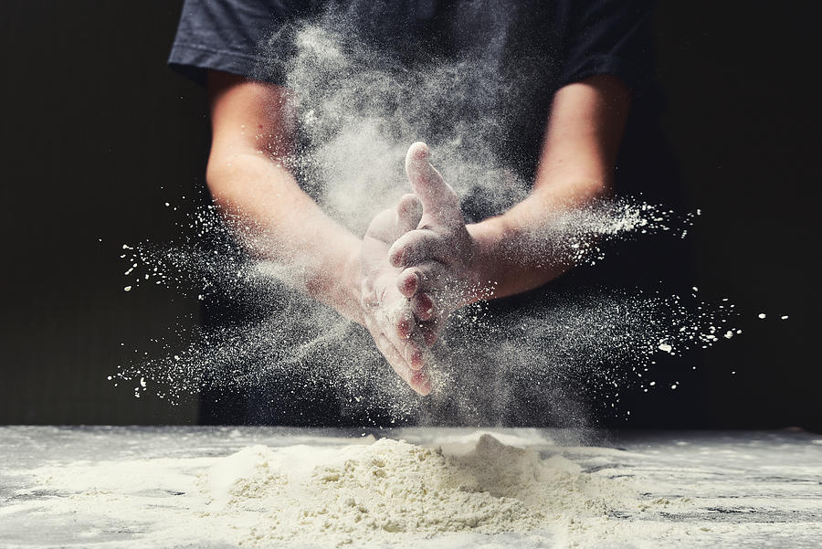 Clap hands of baker with flour in kitchen Photograph by YaroslavKryuchka