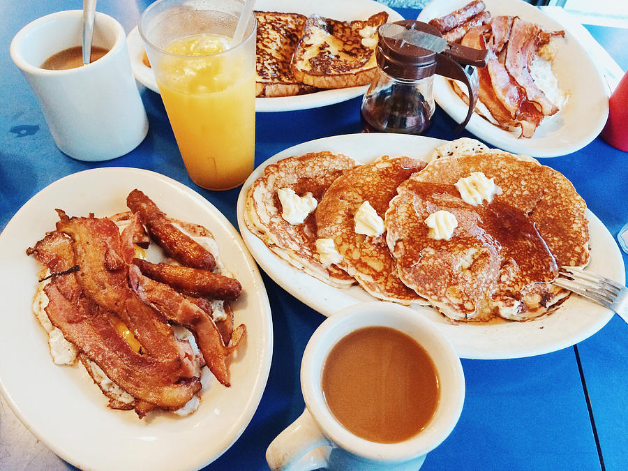 Classic American breakfast with fried eggs, bacon, pancakes, maple syrup and coffee served in a diner Photograph by Alexander Spatari