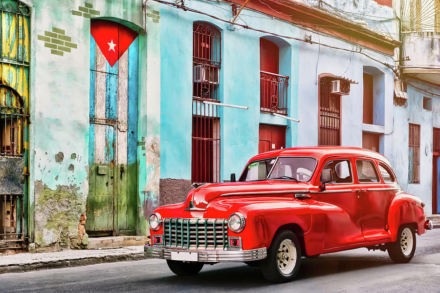 Classic car and and old building with the cuban flag in Havana Photograph by Karel Miragaya