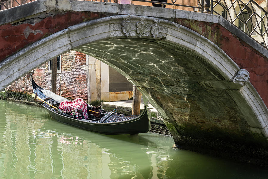 Classic Venetian - a Gondola a Bridge and a Canal Photograph by Georgia Mizuleva