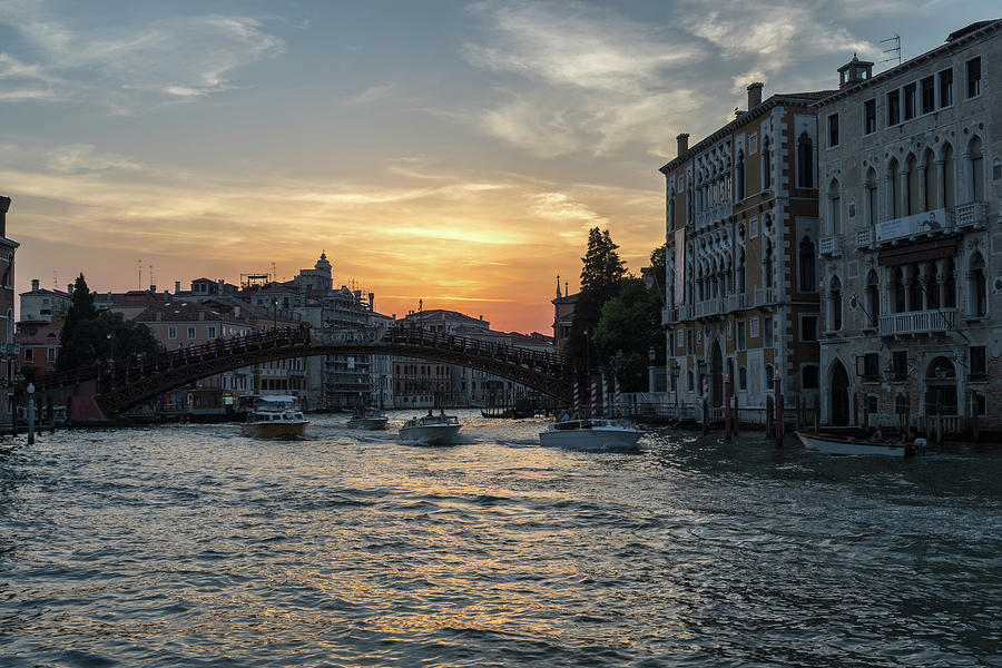Classic Venetian - Sunset Boat Traffic under the Accademia Bridge on the Grand Canal Photograph by Georgia Mizuleva