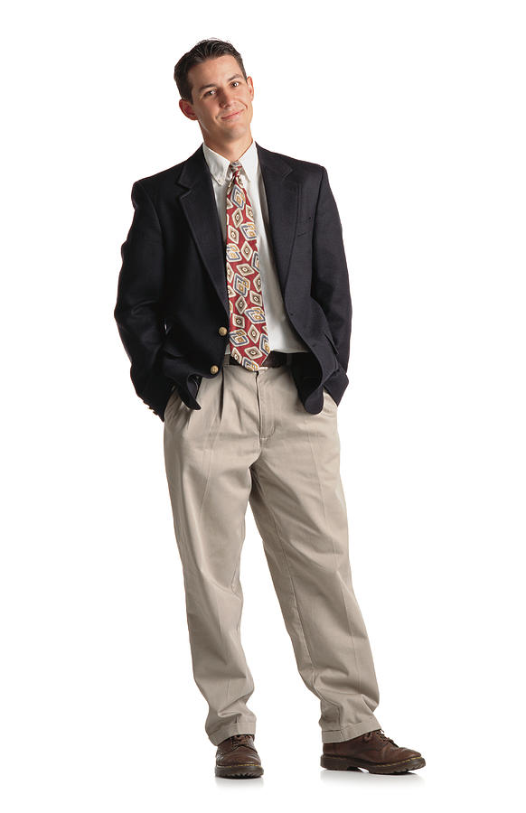 Classy Young Buisness Man In A Suit With Tie And Khaki Pants And Navy Blazer Standing With Weight Shifted And A Smirk On His Face Photograph by Photodisc