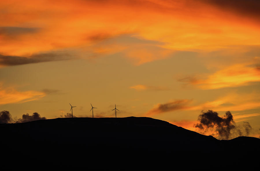 Clean energy power concept with wind turbine on top of a mountain during dramatic sunset Photograph by Arpan Bhatia