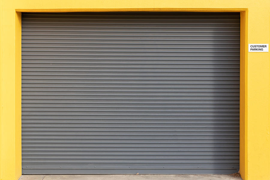 Clean Vehicle Roller Door Set in Bright Yellow Surround Photograph by Colin Wilson