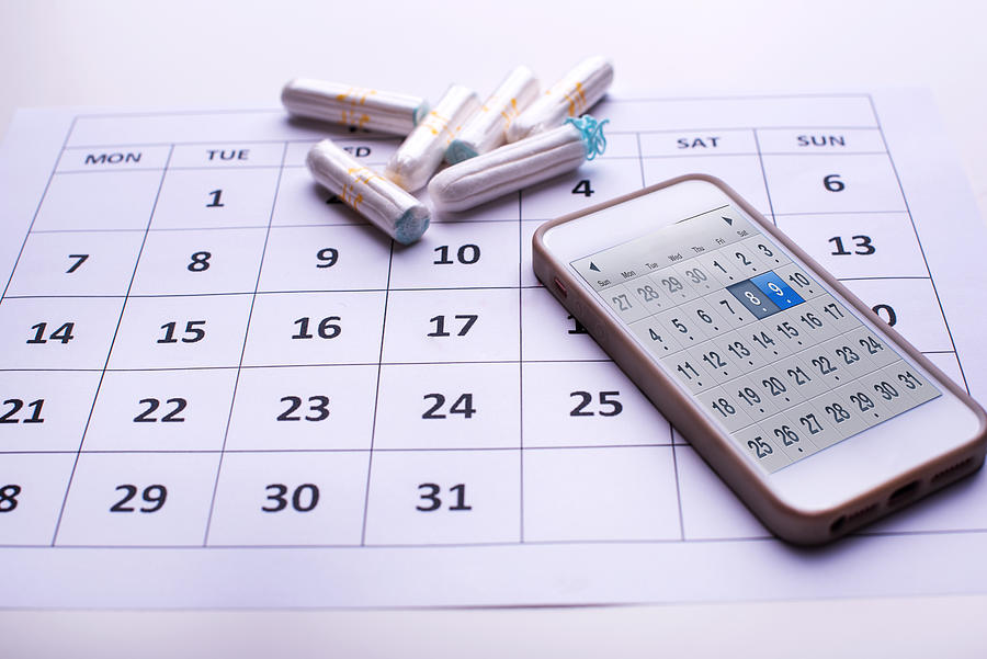 Clean white tampons, mobile phone and Calendar Photograph by Emilija Manevska