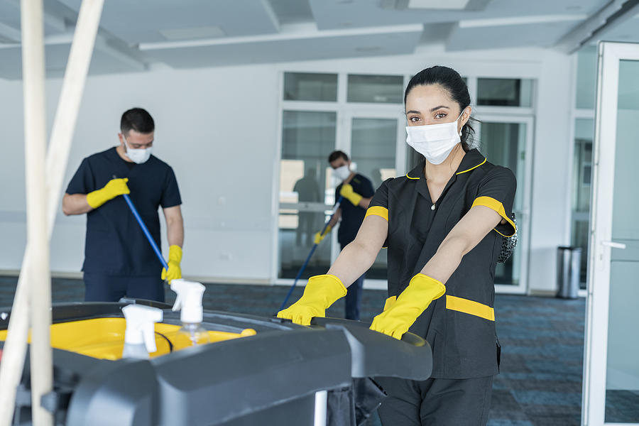 Cleaning staff is cleaning the building to avoid the risk of contagion by COVID-19 Photograph by RicardoImagen