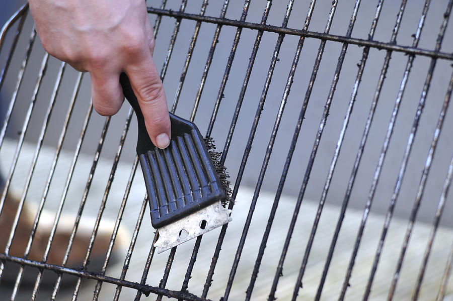 cleaning the grill with scrubber - Grillbürste Photograph by Wakila