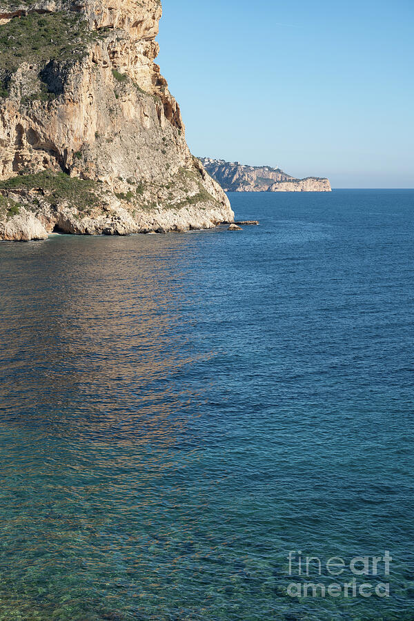 Cliffs And Subtle Reflections In Clear Seawater Photograph