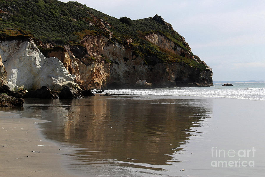 Cliffs Reflected On Sand Photograph