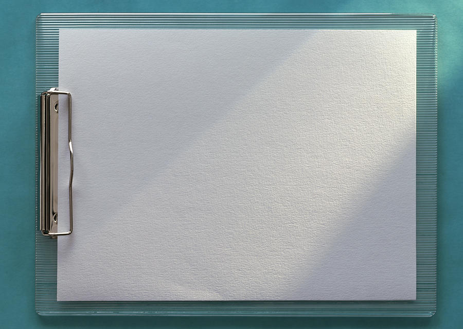 Clipboard holding blank white paper, horizontal, full length, close-up, teal background Photograph by Isabelle Rozenbaum
