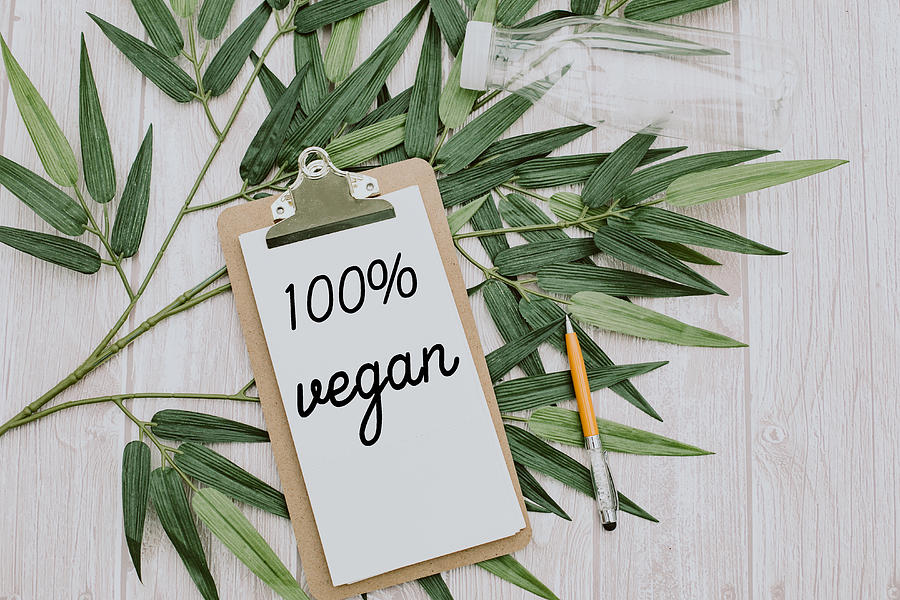 clipboard  with 100% vegan text.Top view Photograph by Carol Yepes