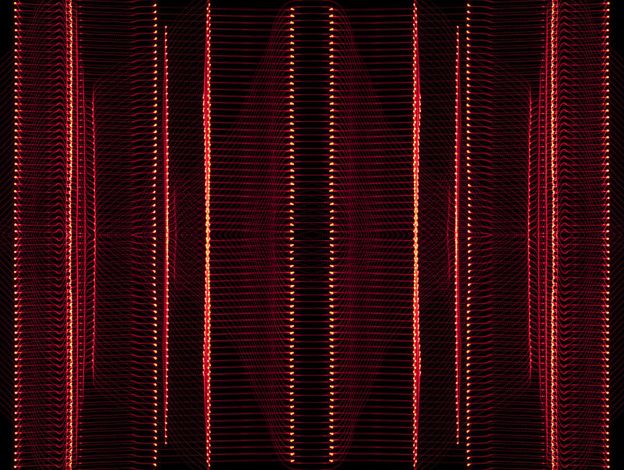 Close-up abstract pattern of intertwined colorful light beams of color red on a  black background. Photograph by Jose A. Bernat Bacete