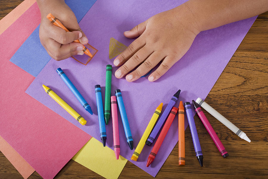 Close up hands of child drawing with colorful crayons Photograph by Kali9