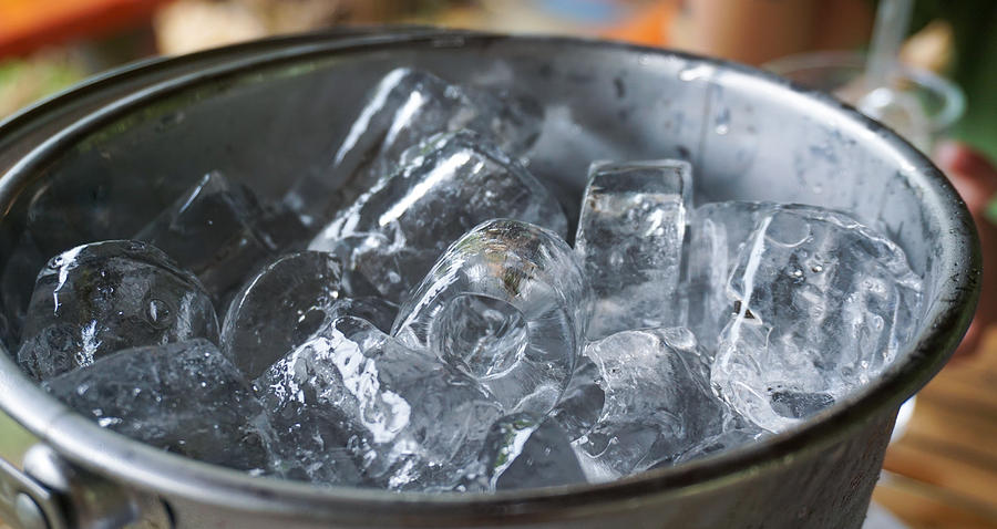 Close up ice cubes in bucket. Photograph by Urvashi9