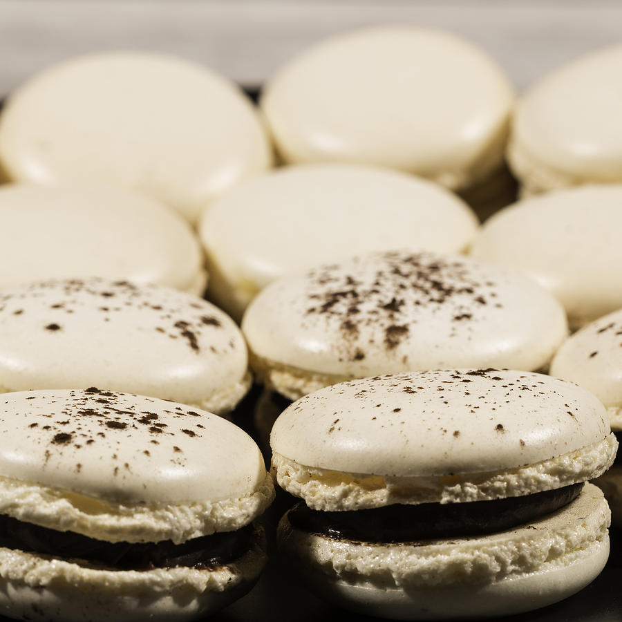 Close-up Macaroons lined up in a dish Photograph by Jean-Marc PAYET