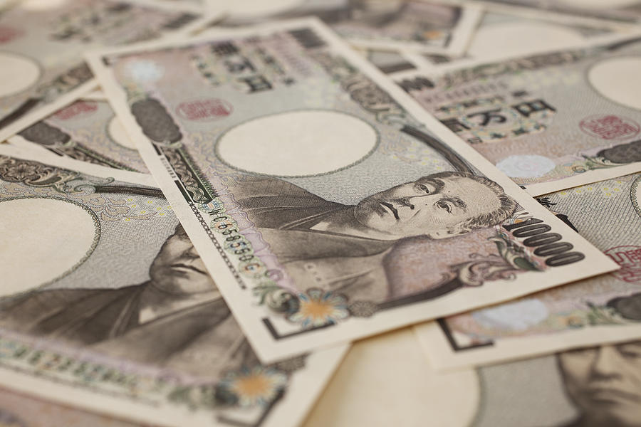 Close-up of 10,000 Japanese yen bills Photograph by Plusphoto
