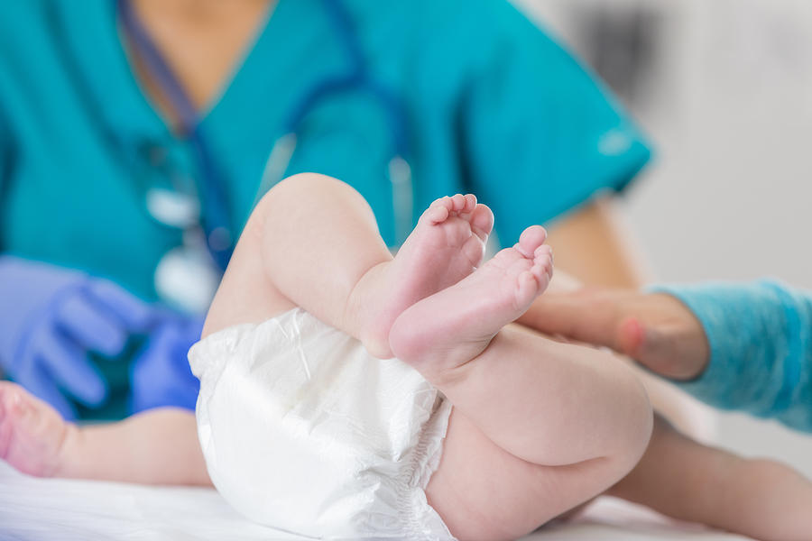Close up of a babys feet during medical exam Photograph by SDI Productions