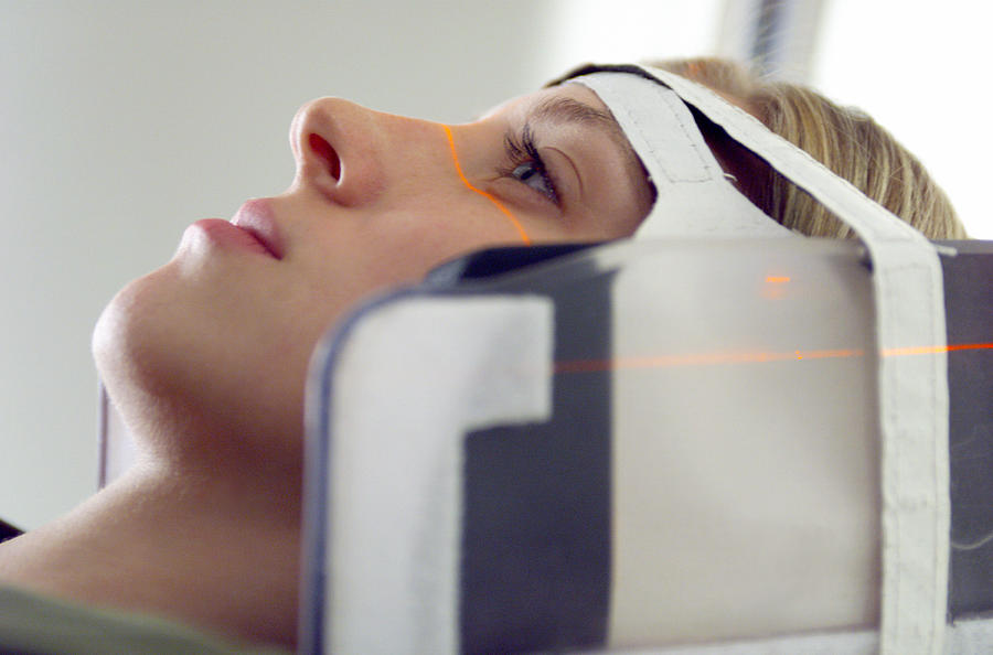 Close Up Of A Blonde Caucasian Female Patient As Her Head Is Strapped Into A Cat Scan Machine Photograph by Photodisc