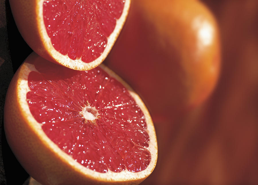 Close-up Of A Cut Open Grapefruit Photograph by Stockbyte