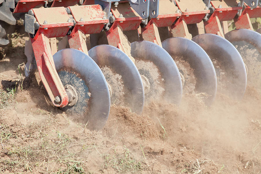 Farm Photograph -  Close up of a disc harrow system, cultivate the soil by Michael Dechev