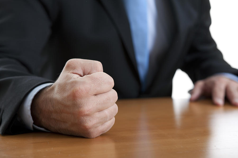 Close-up of a fist of a furious businessman on a table Photograph by Aphrodite74