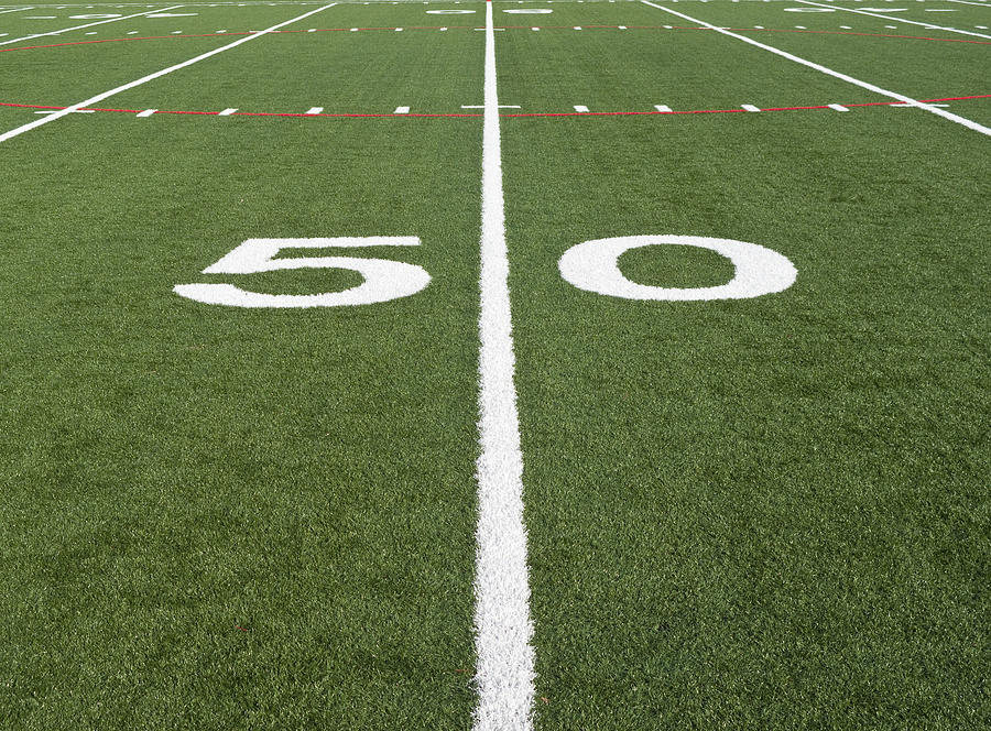 Close up of a football field at the fifty yard line Photograph by Bruceman