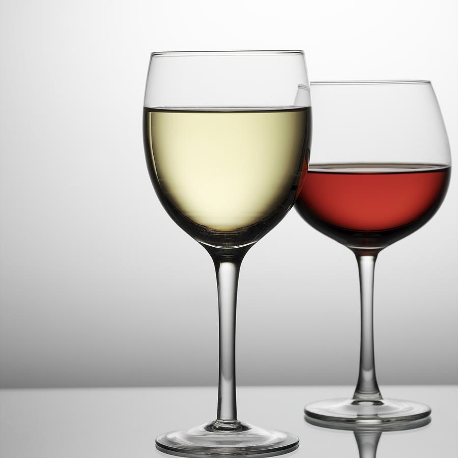 Close-up of a glass of white wine with a glass of red wine in the background Photograph by Ciaran Griffin