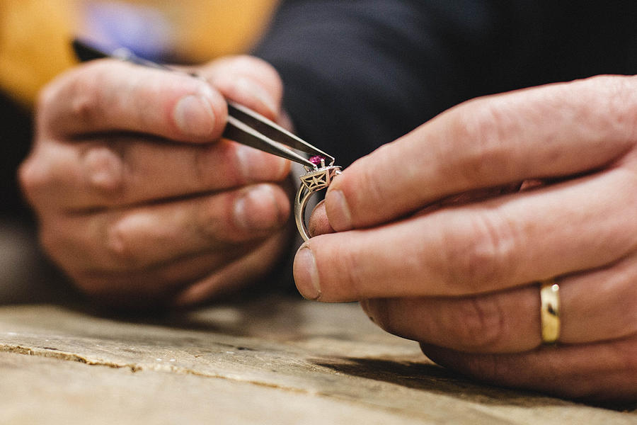 Close-up of a jeweler mounting a gemstone onto a ring Photograph by Anadorado