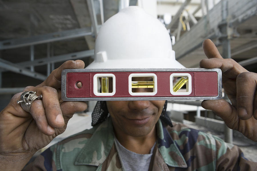 Close-up of a male construction worker holding a level Photograph by Glowimages