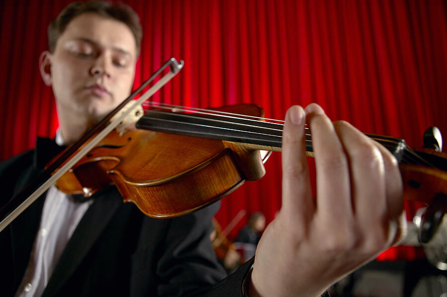 Close-Up of a Male Violinist Performing Photograph by Digital Vision.