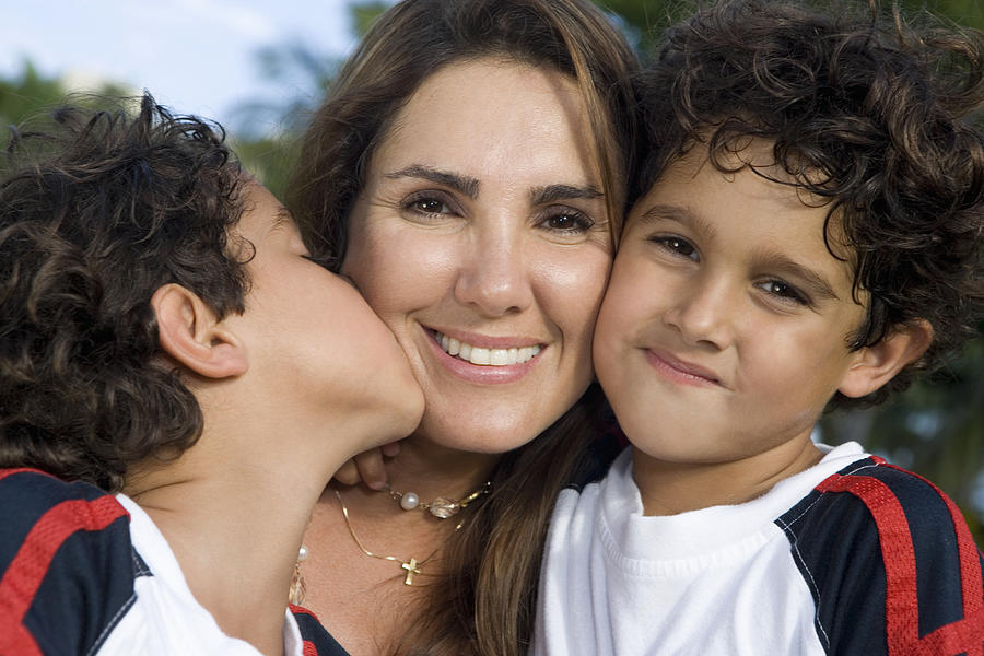Close-up of a mid adult woman with her two sons Photograph by Glowimages