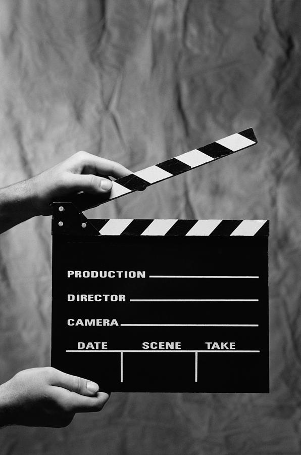 Close-up of a persons hands holding a clapperboard (black and white) Photograph by George Doyle