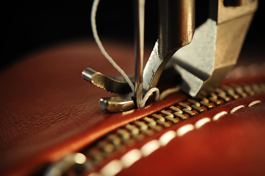 Close-up of a sewing machine with needle on red leather Photograph by Maxrale