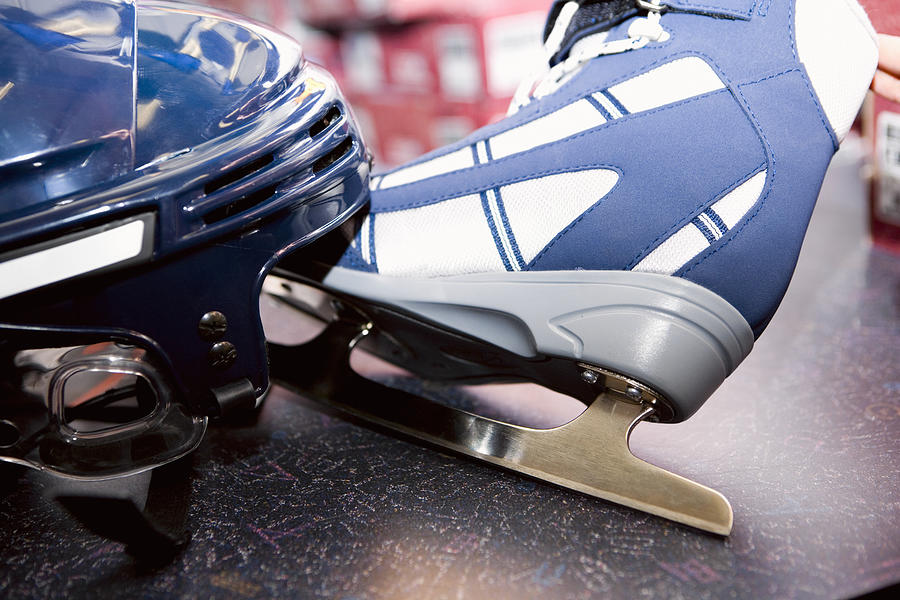 Close-up of a sports helmet with an ice-skate Photograph by Glowimages