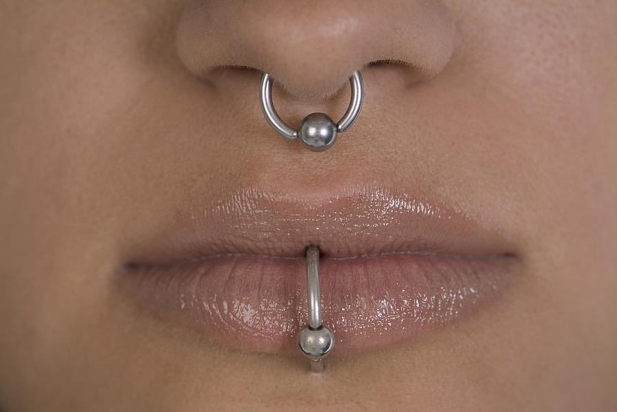 Close-up of a womans nose and mouth with piercing Photograph by Medioimages/Photodisc