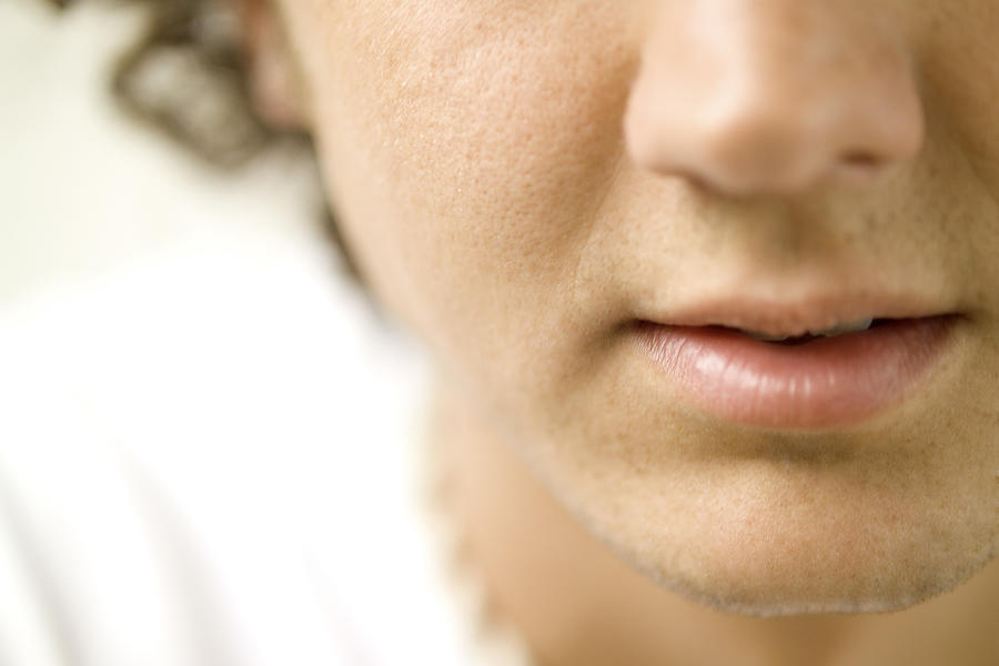 Close-up of a young mans nose and mouth Photograph by Medioimages/Photodisc