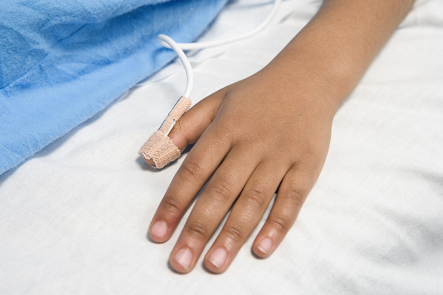 Close up of African childs hand with pulse on hospital bed Photograph by Shannon Fagan Close up of African childs hand with pulse on hospital bed Photograph by Shannon Fagan