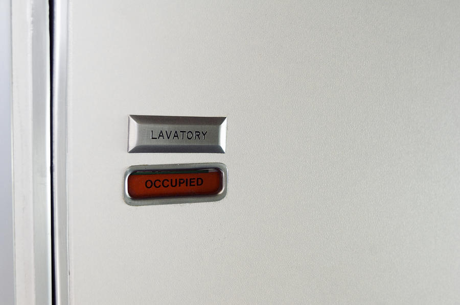 Close-up of airline lavatory door with sign reading occupied Photograph by Chase Jarvis