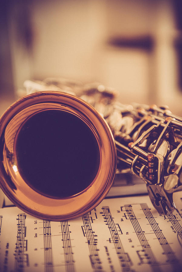 Close-up of Alto Saxophone on Music Sheet, Brown Tones Photograph by Ababsolutum