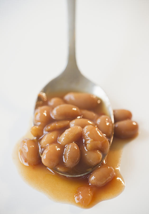 Close up of baked beans on spoon Photograph by Jamie Grill
