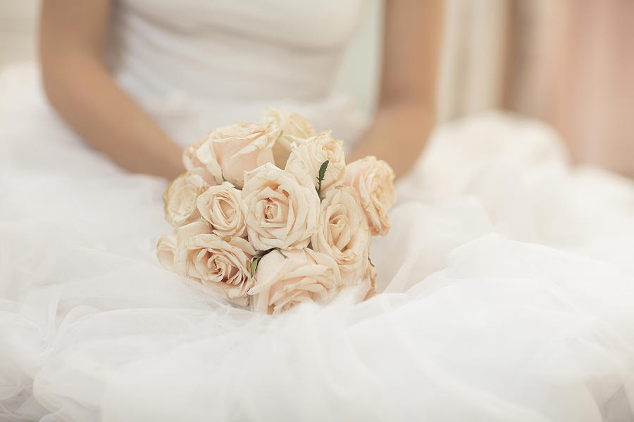 Close up of bride holding bouquet of flowers Photograph by Lumina Images